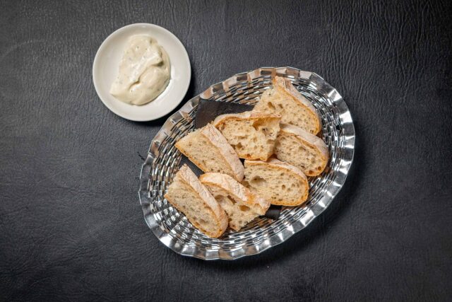 Freshly made Alioli in tapas bar restaurant Mayfair with bread, pan.