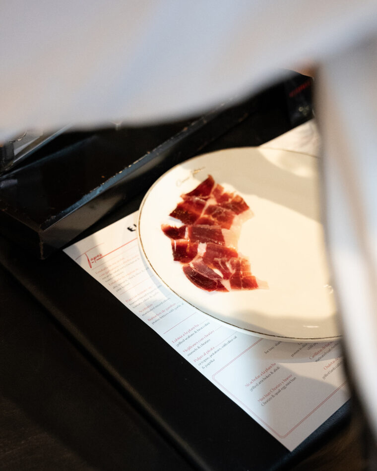 Jamon iberico ham traditional plating in restaurant