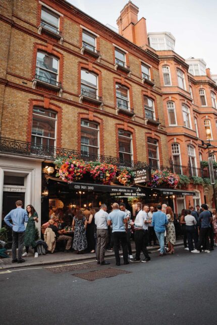Mayfair wine tapas bar group crowd outside Down Street Hyde Park Corner