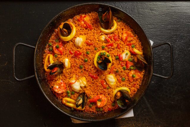 Seafood paella served in a traditional iron pan famous Spanish dish