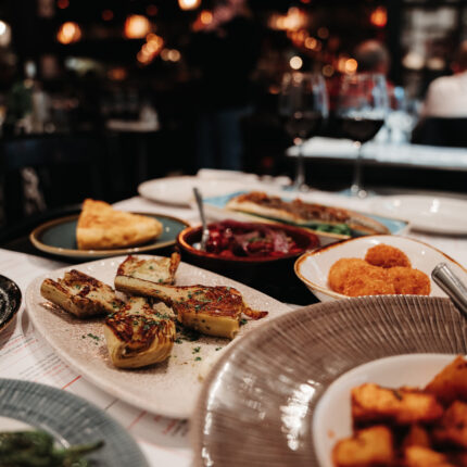 A rustic wooden table filled with various traditional Spanish tapas dishes.