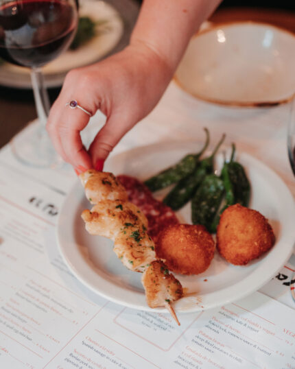 Tapas chicken skewers small plate dishes at the bar