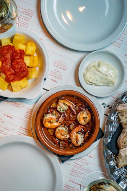 Tapas small plates Alioli patatas bravas prawns with garlic served at the bar