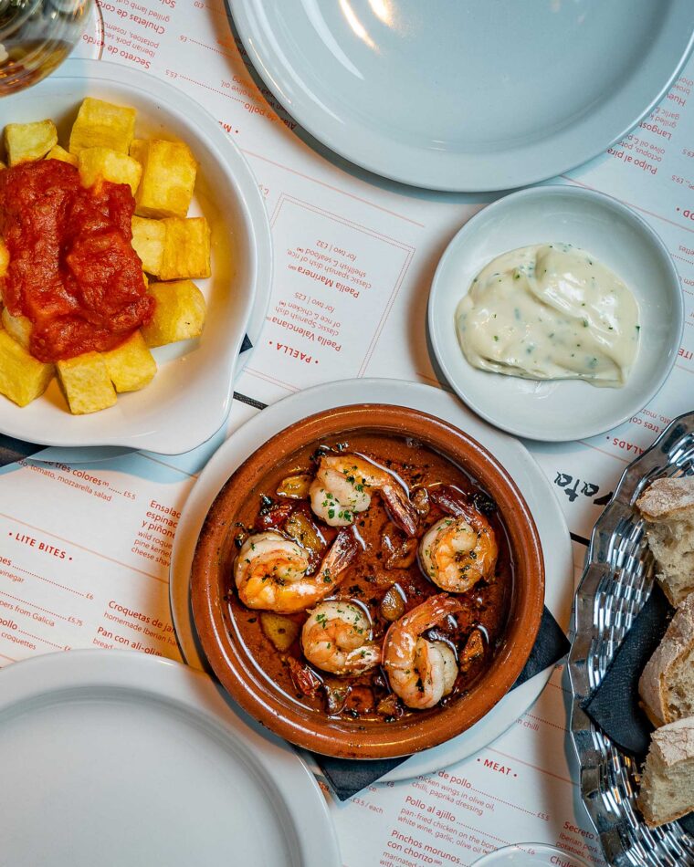 Tapas small plates Alioli patatas bravas prawns with garlic served at the bar